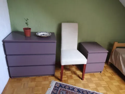 View of a part of the bedroom with a dresser, a chair, and a bed. - image 7