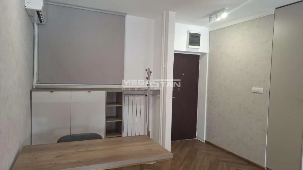 Smaller bedroom with a bed, wardrobe, and a desk.