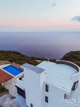 Aerial view of a villa with a swimming pool and sea view. - image 35