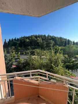 View from the balcony towards the green hill and surroundings. - image 5