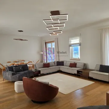 Spacious living room with a sofa set, dining area, and modern lighting. - image 4