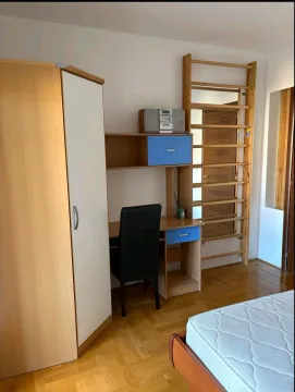 Children's bedroom with a wardrobe, desk, and bed. - image 5