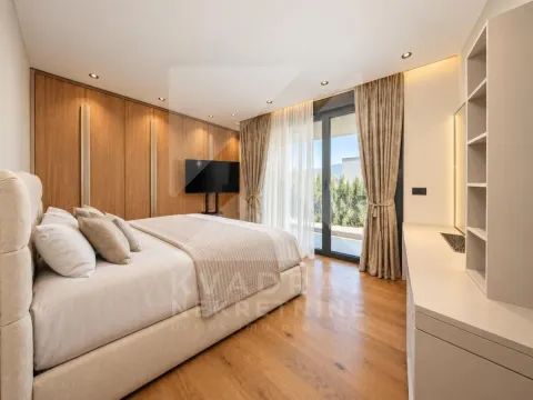 Modern bedroom with a double bed, wooden wall panels, and access to the terrace. - image 5