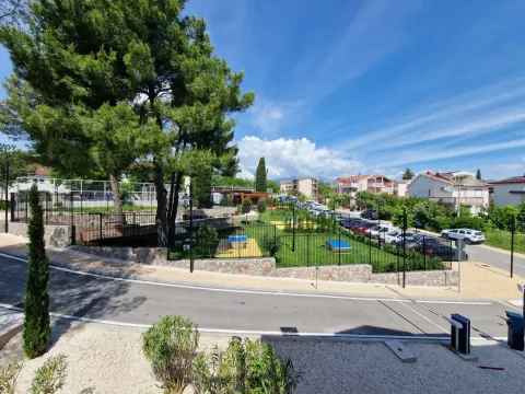 View of the courtyard and surrounding buildings with greenery. - image 11