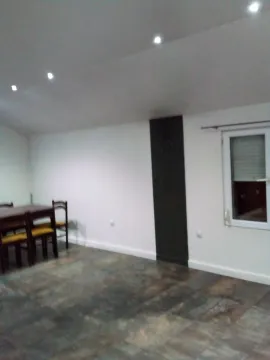 A simple room featuring a dining table and chairs. - image 2