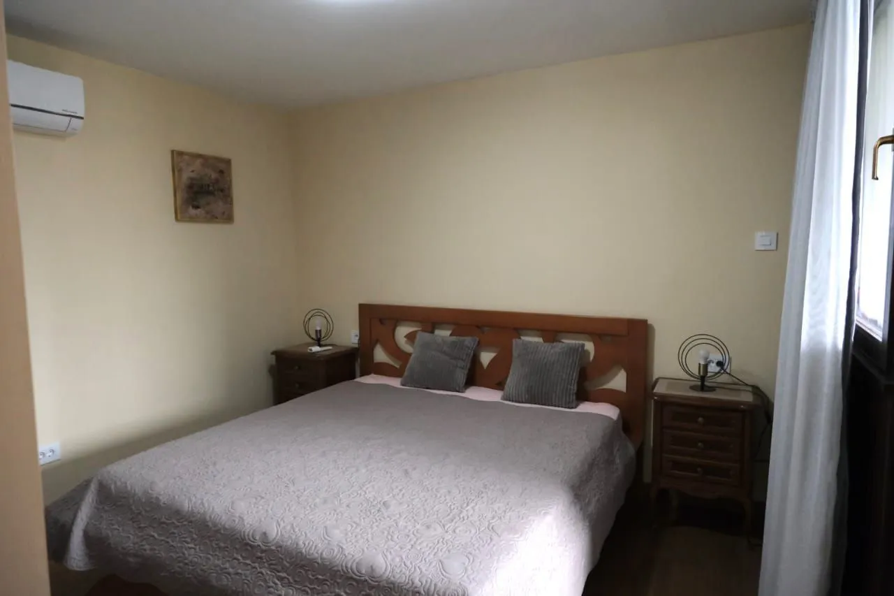 Simple bedroom with a double bed and nightstands.