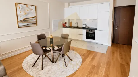 Modern kitchen with dining area and white cabinetry. - image 7