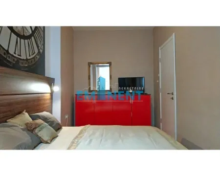 Furnished bedroom with a double bed, a red chest of drawers and a TV. - image 11