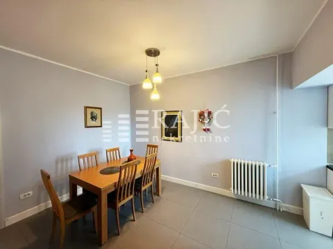 Dining room with a wooden table and chairs. - image 3