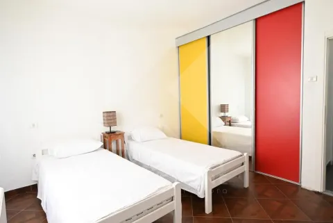 Bedroom with two single beds and a large built-in wardrobe with a mirror. - image 19