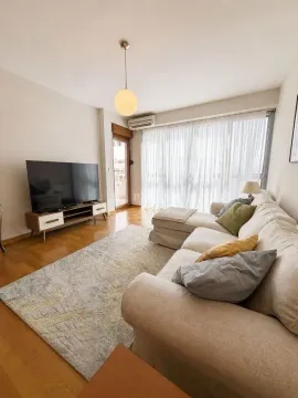Bright living room with a sofa, TV unit, and access to the terrace. - image 2