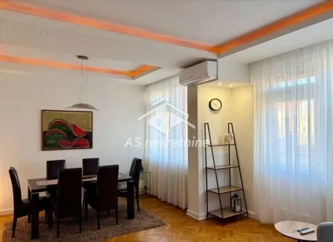 Living room with a dining table and chairs, parquet flooring, and ambient lighting. - image 6