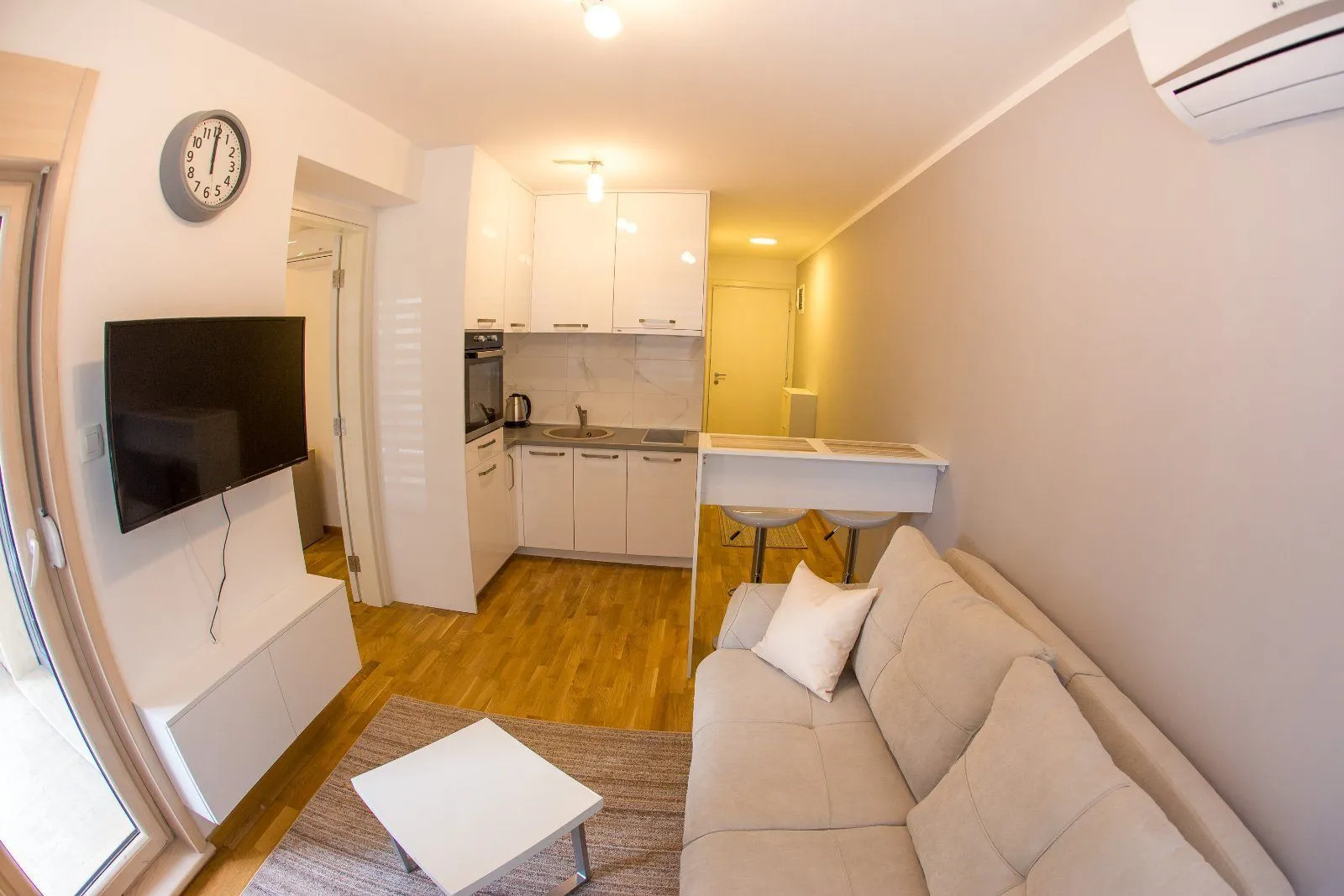 Living room with kitchen and dining area.