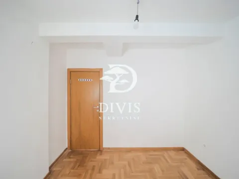Empty room with wooden parquet flooring and a wooden door. - image 5