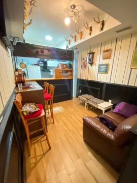 Living room with a bar and seating area. - image 2