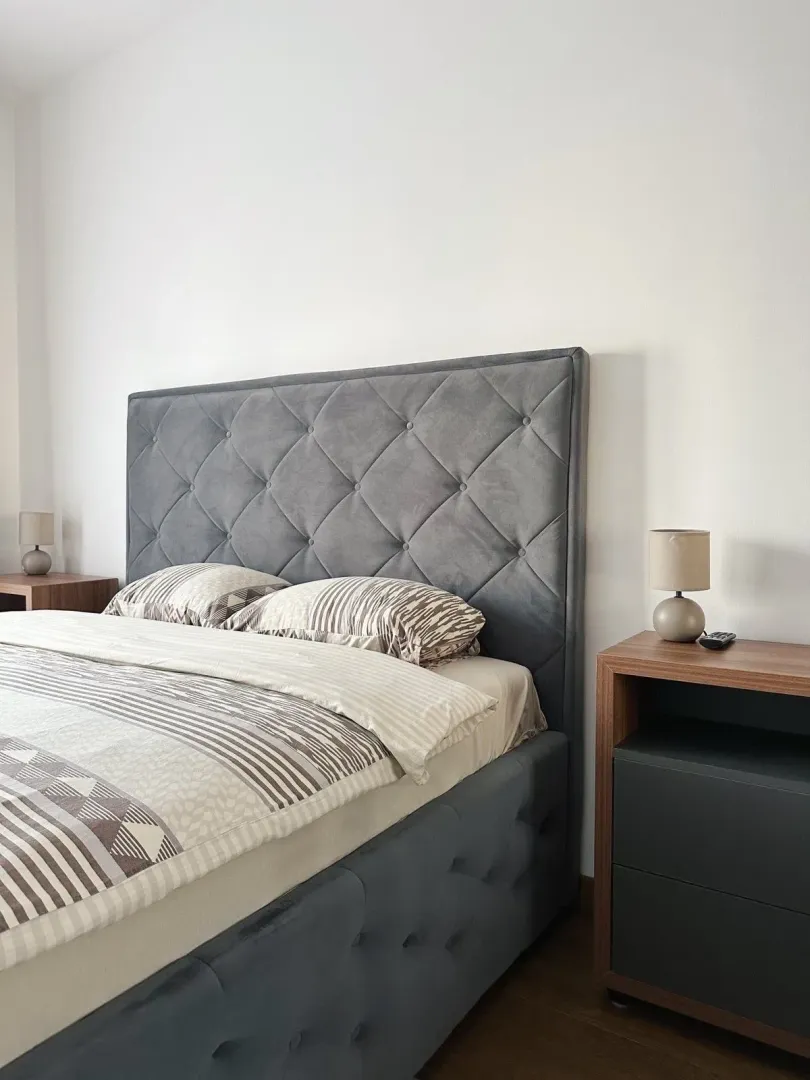 Furnished bedroom with a double bed and nightstands.