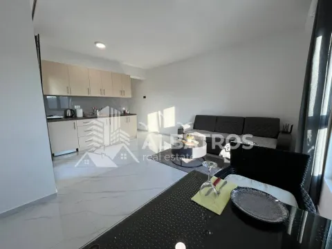 Living room with open-plan kitchen and dining area. - image 5