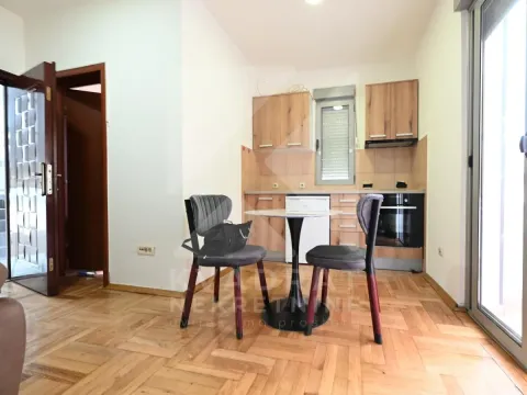 Small kitchen with a dining table and chairs. - image 11