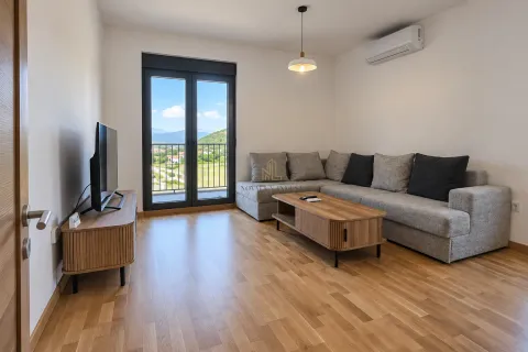 Living room with a sectional sofa, TV, and access to the terrace. - image 2