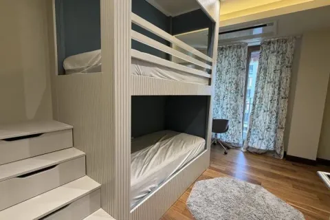 Bedroom with a bunk bed and stairs featuring built-in drawers. - image 7