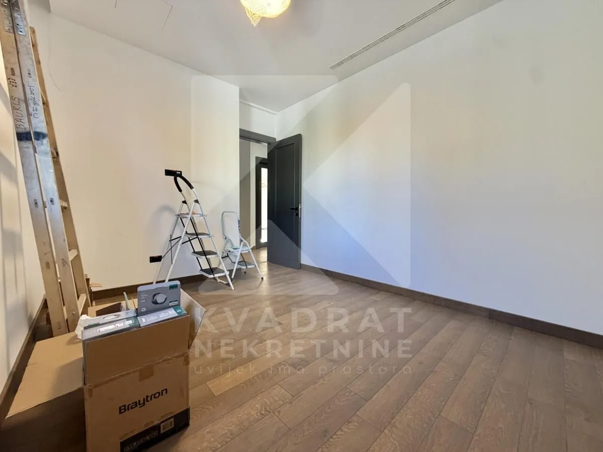 Empty room with wooden flooring during renovation.