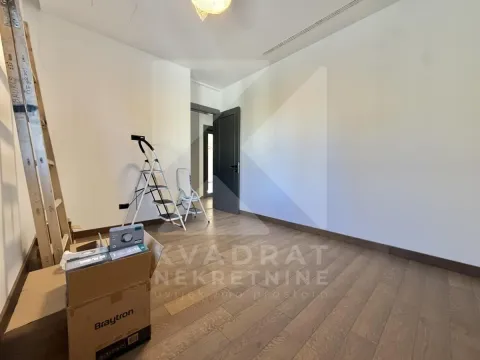 Empty room with wooden flooring during renovation. - image 21