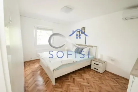 Bright bedroom with a double bed, parquet flooring, and an air conditioning unit. - image 7