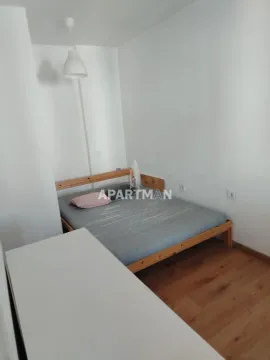 Spavaća soba sa bračnim krevetom i drvenim podom. - image 4