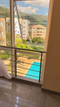 View from the terrace overlooking the swimming pool and surrounding buildings. - image 3
