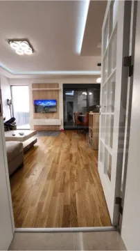 Living room with wooden flooring and access to the terrace. - image 2