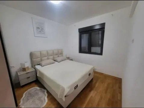 Bedroom with a large double bed, bedside tables and a window. - image 7