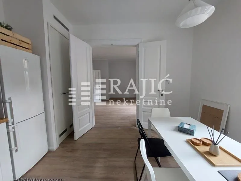 Dining area with a dining table and a view of the apartment's interior.
