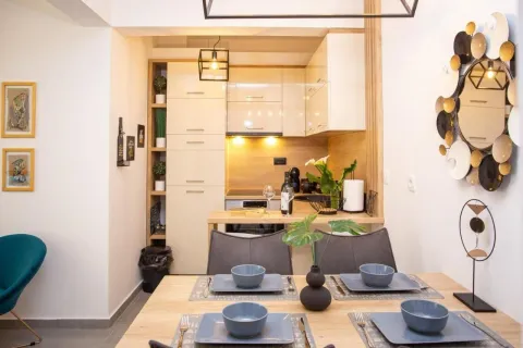 Dining area connected to a modernly equipped kitchen. - image 8