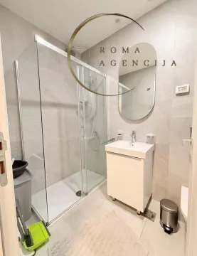 Modern bathroom with a shower cabin, sink, and mirror. - image 7