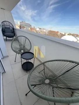 Furnished balcony with seating furniture and a city view. - image 9