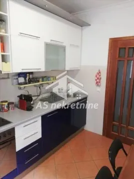 View of the kitchen with white and blue cabinetry. - image 7