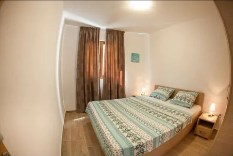 Furnished bedroom with a double bed and a window. - image 6