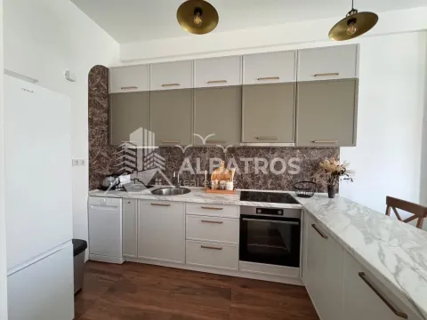 Modern kitchen with built-in appliances and a breakfast bar. - image 5