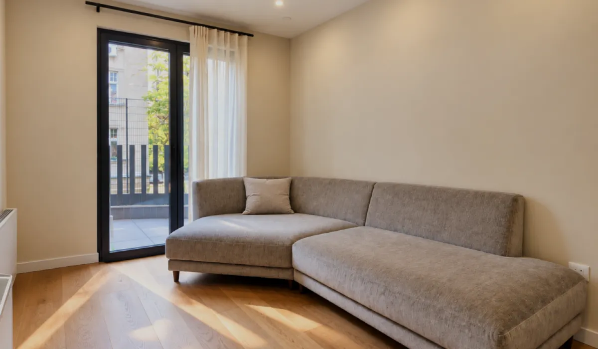 Living room with a sectional sofa and access to the terrace.