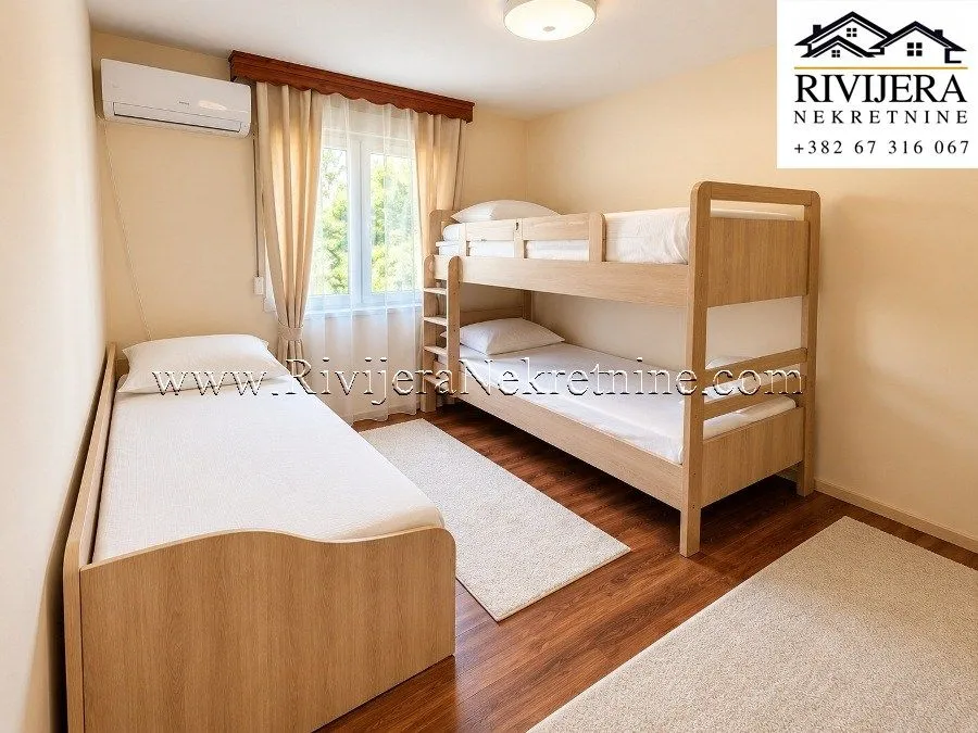 Children's bedroom with a bunk bed and an additional single bed.