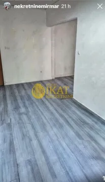A view of an empty room with grey laminate flooring. - image 3