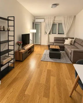 Living room with a sectional sofa, TV unit, and shelving. - image 2