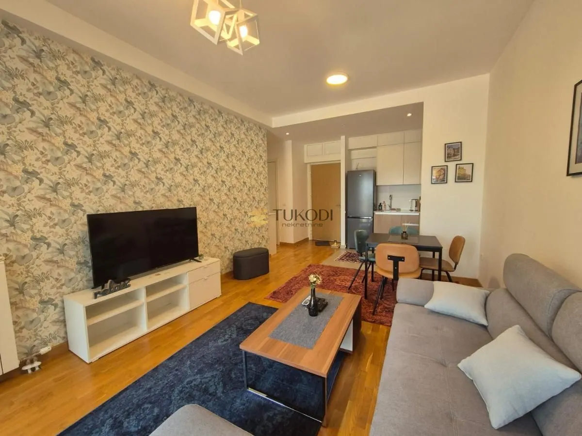 Living room connected with dining area and kitchen.