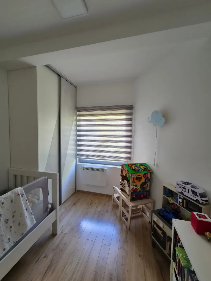 Dječija soba sa krevetcem, ugradnim plakarom i igračkama.