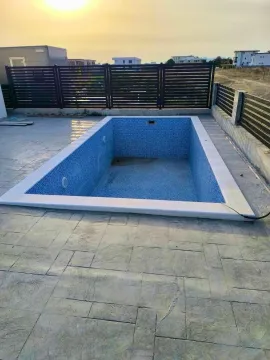 Yard with an empty swimming pool and a fence. - image 20