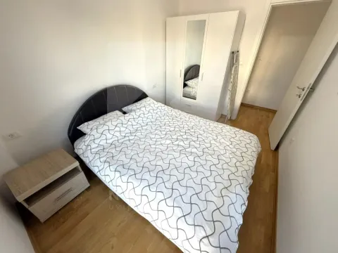 Furnished bedroom with a double bed, wardrobe, and a nightstand. - image 4