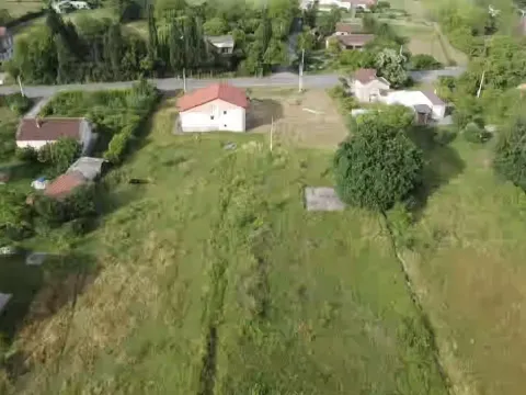 Aerial view of a spacious plot with a house and greenery. - image 3