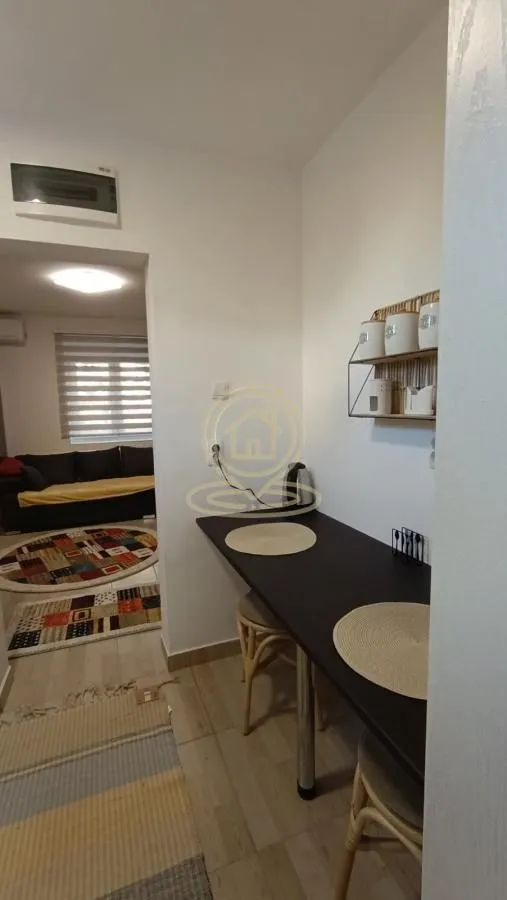 Manja kuhinja sa šankom i stolicama za sedenje.