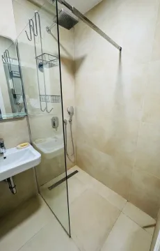 Small bathroom with a walk-in shower and a sink. - image 6