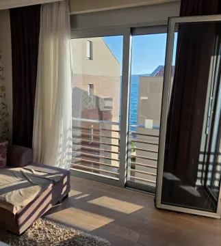 Living room with a sofa and access to a terrace with a sea view. - image 6